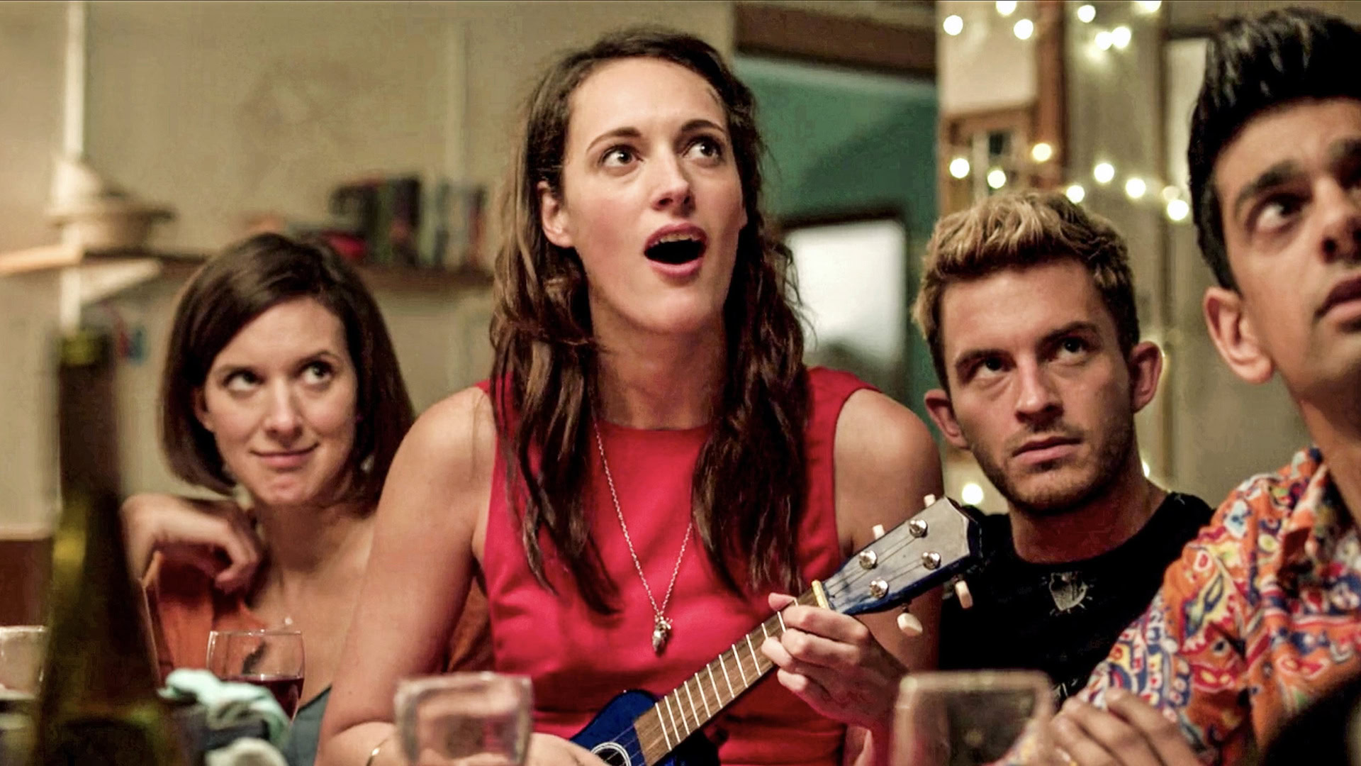 Phoebe Waller-Bridge playing a ukulele with the main cast of Crashing - best british shows on netflix