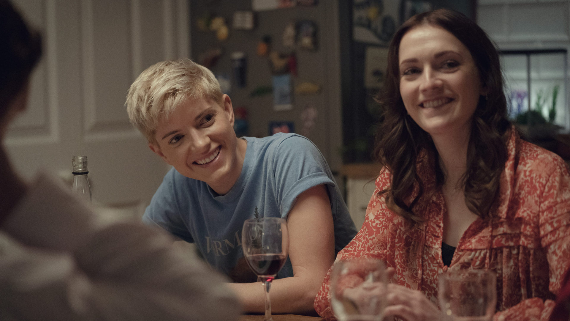 Mae Martin and Charlotte Ritchie at a dinner table in Feel Good - best british shows on netflix