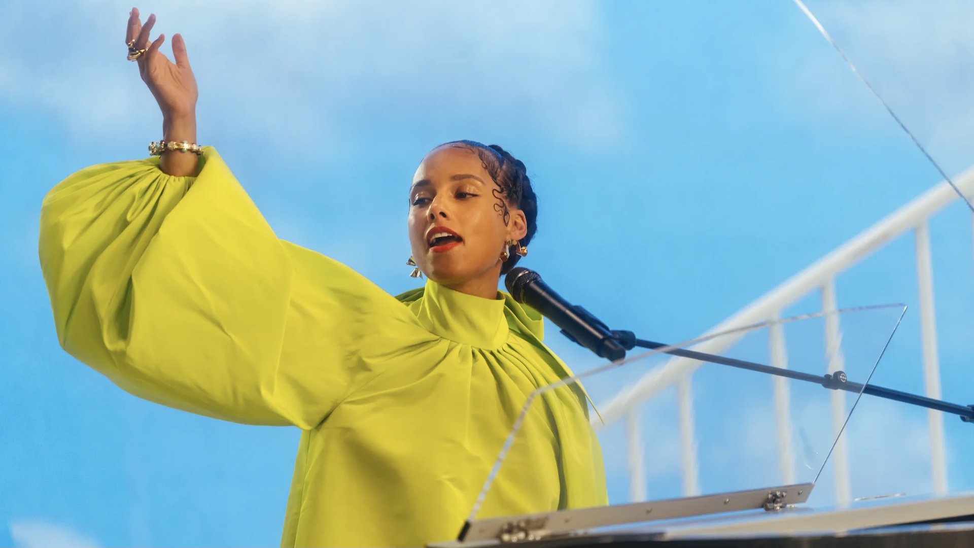 Alicia Keys waves from a piano in Noted: Alicia Keys the Untold Stories
