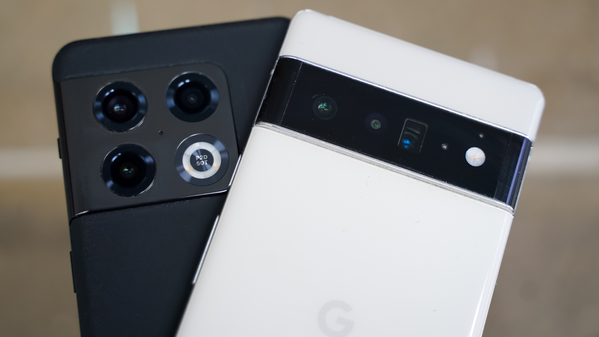 OnePlus 10 Pro vs Google Pixel 6 Pro cameras in front of brick