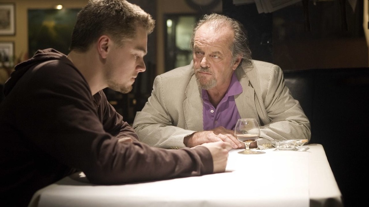 Leonardo DiCaprio and Jack Nicholson sit together at a bar in The Departed - best english-language remakes