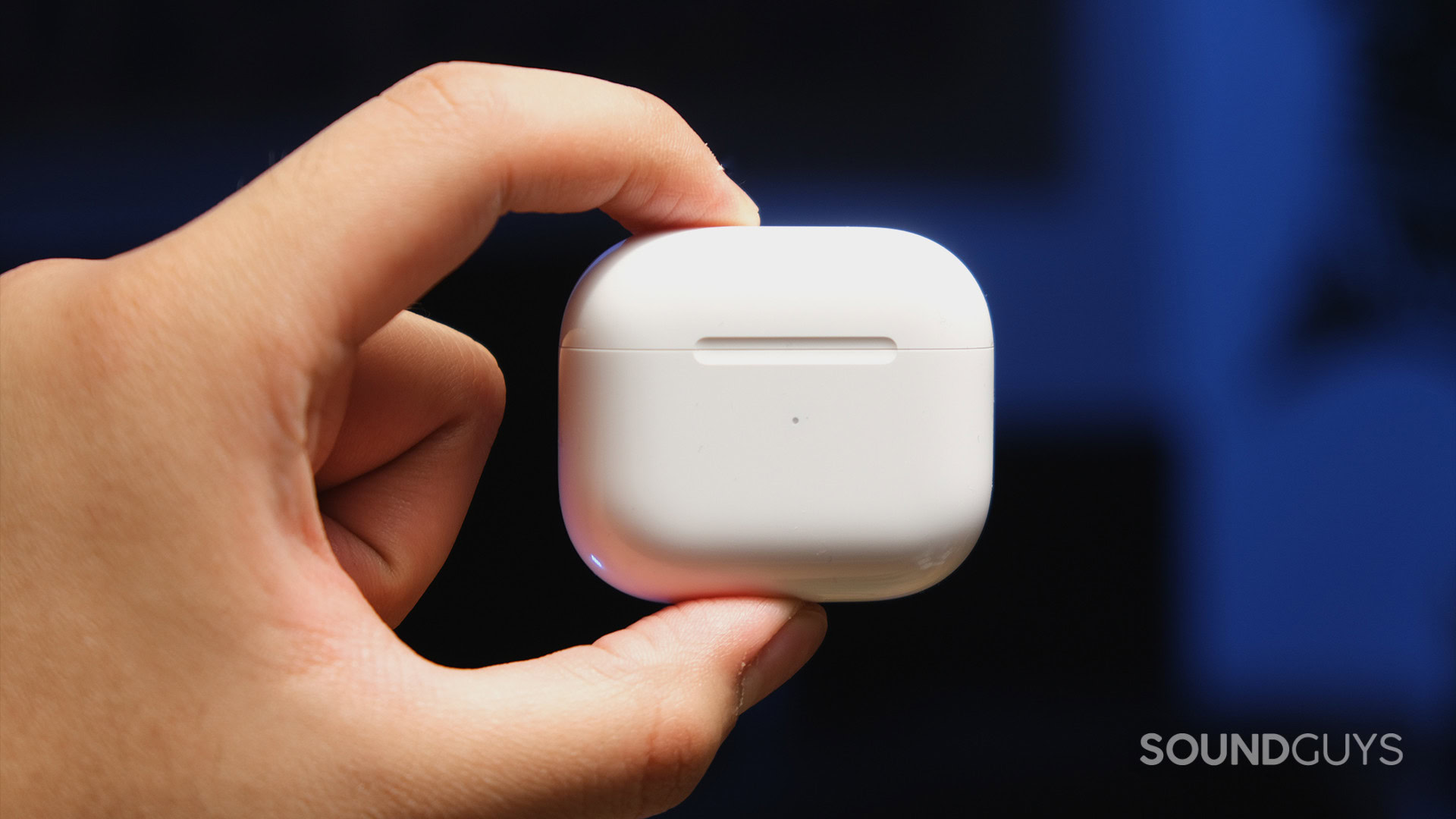 A hand holds the AirPods 3rd Gen case.