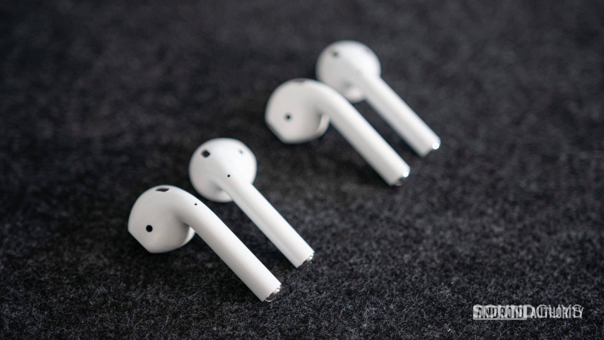 The old and new Apple AirPods (2019) next to each other.