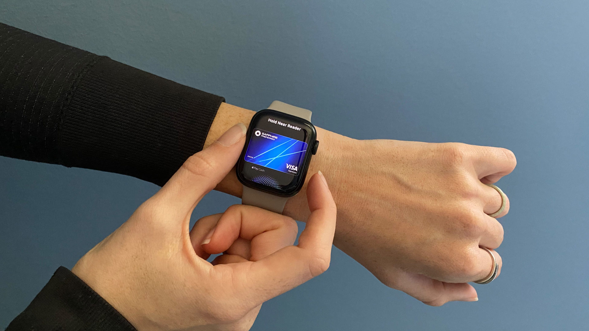 A user activates ApplePay on her Apple Watch by double tapping the side button.