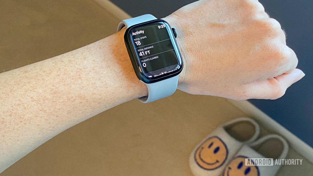 An Apple Watch Series 7 on a user's wrist displays their step count in the Fitness app.