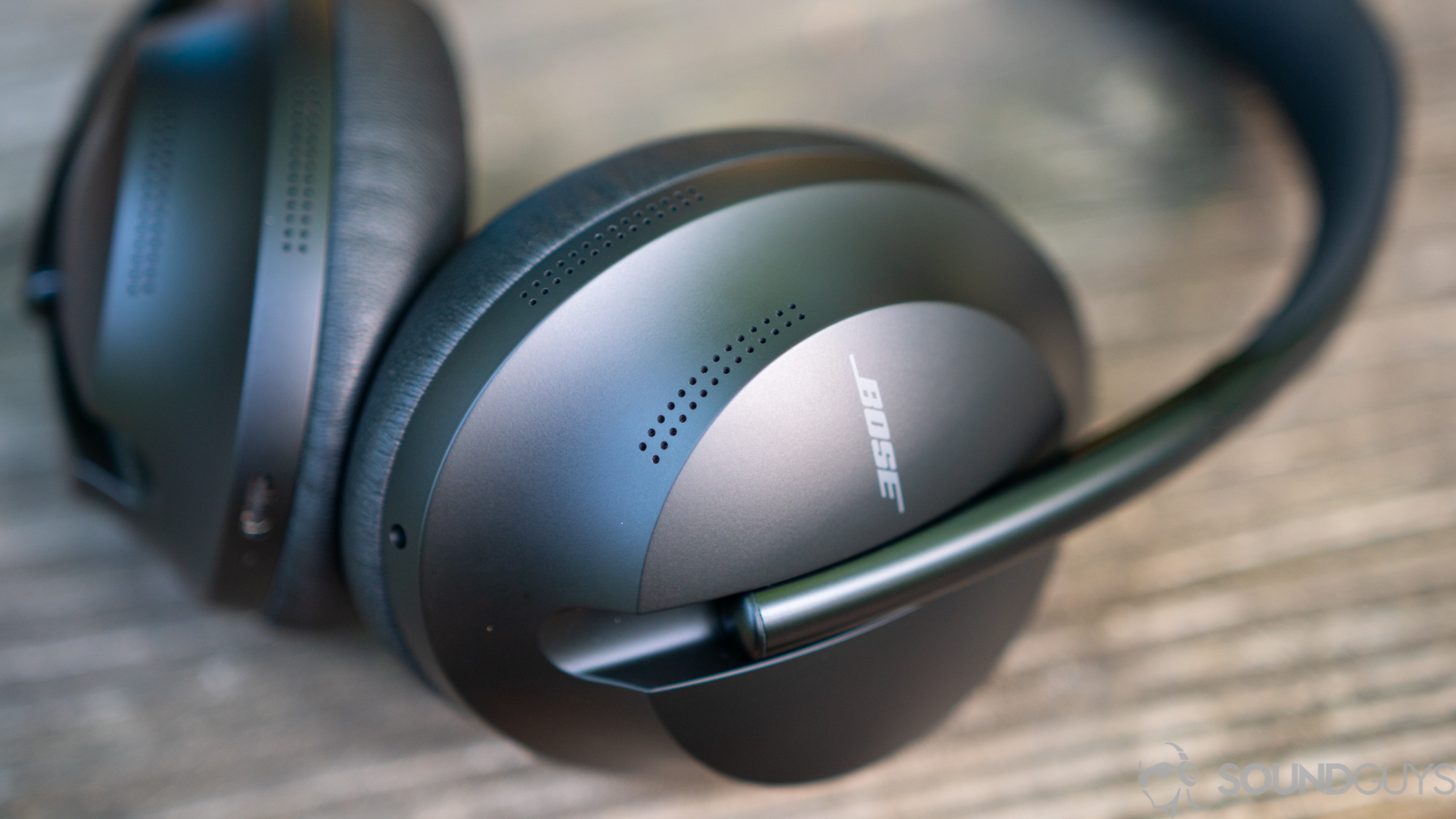 A pair Bose Noise Canceling 700 headphones lying on table.