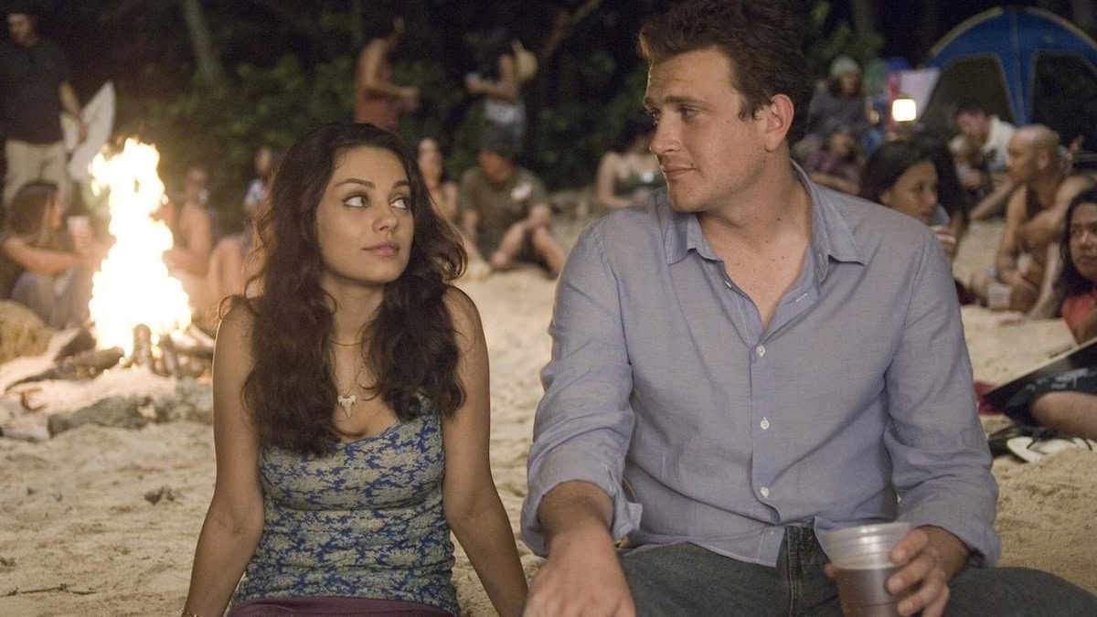 Jason Segel and Mila Kunis sit on the beach together in Forgetting Sarah Marshall - best funny movies on netflix
