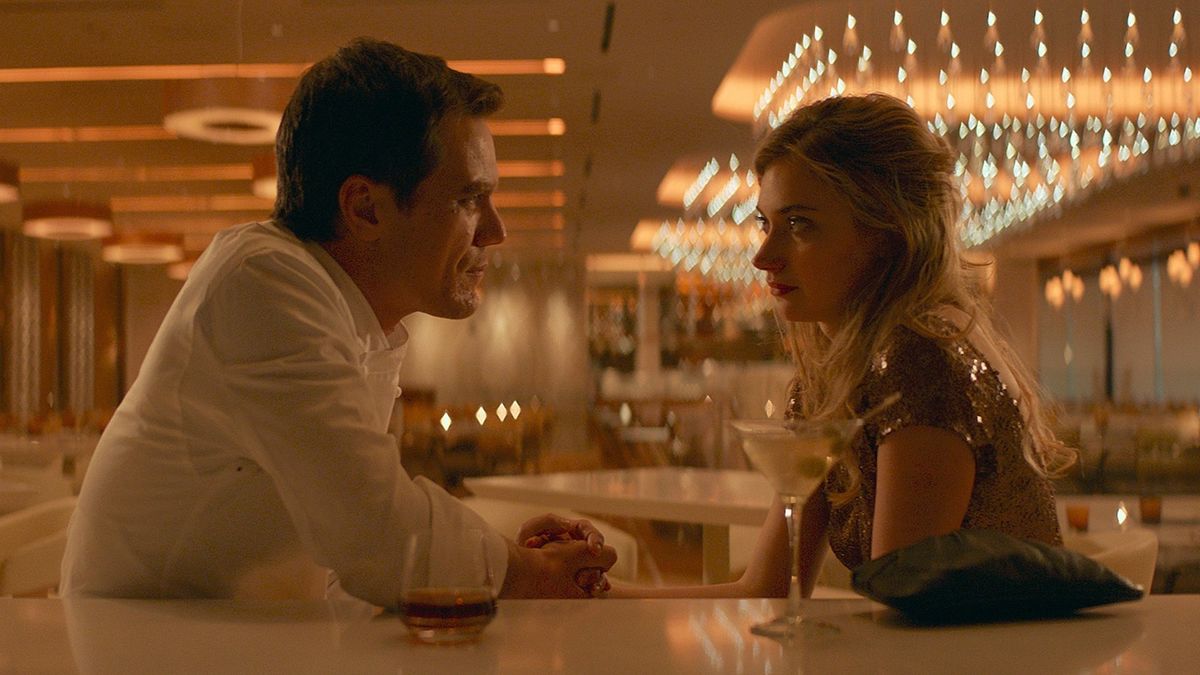 A man and woman sit in a restaurant facing each other in Frank and Lola - steamy movies on netflix