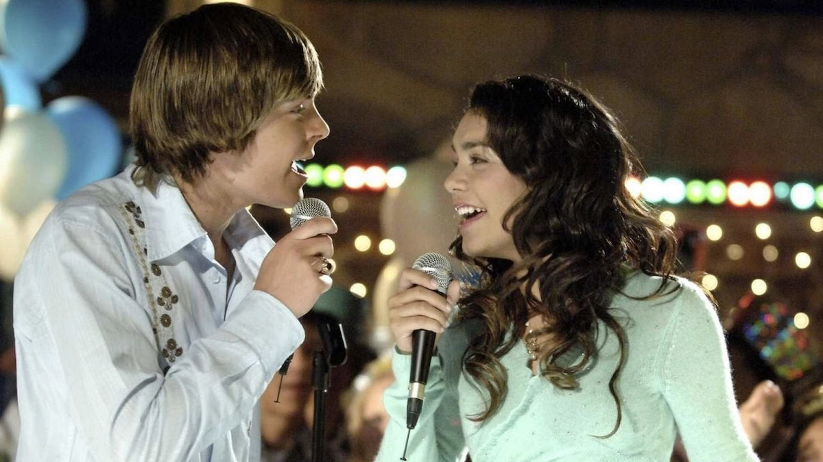 Vanessa Hudgens and Zac Efron sing together in High School Musical - best kids movies on disney plus