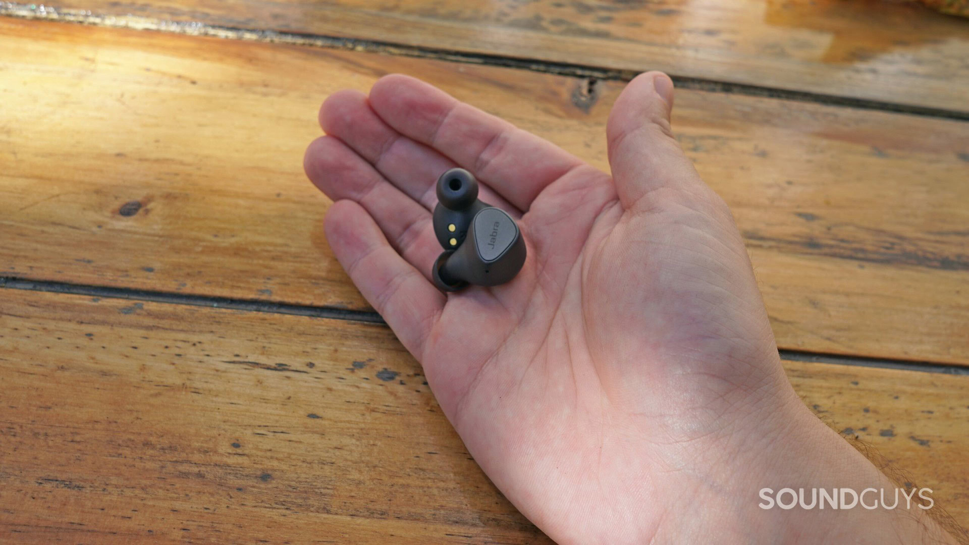 One Jabra Elite 3 earbud in a hand, showing the ear tip.