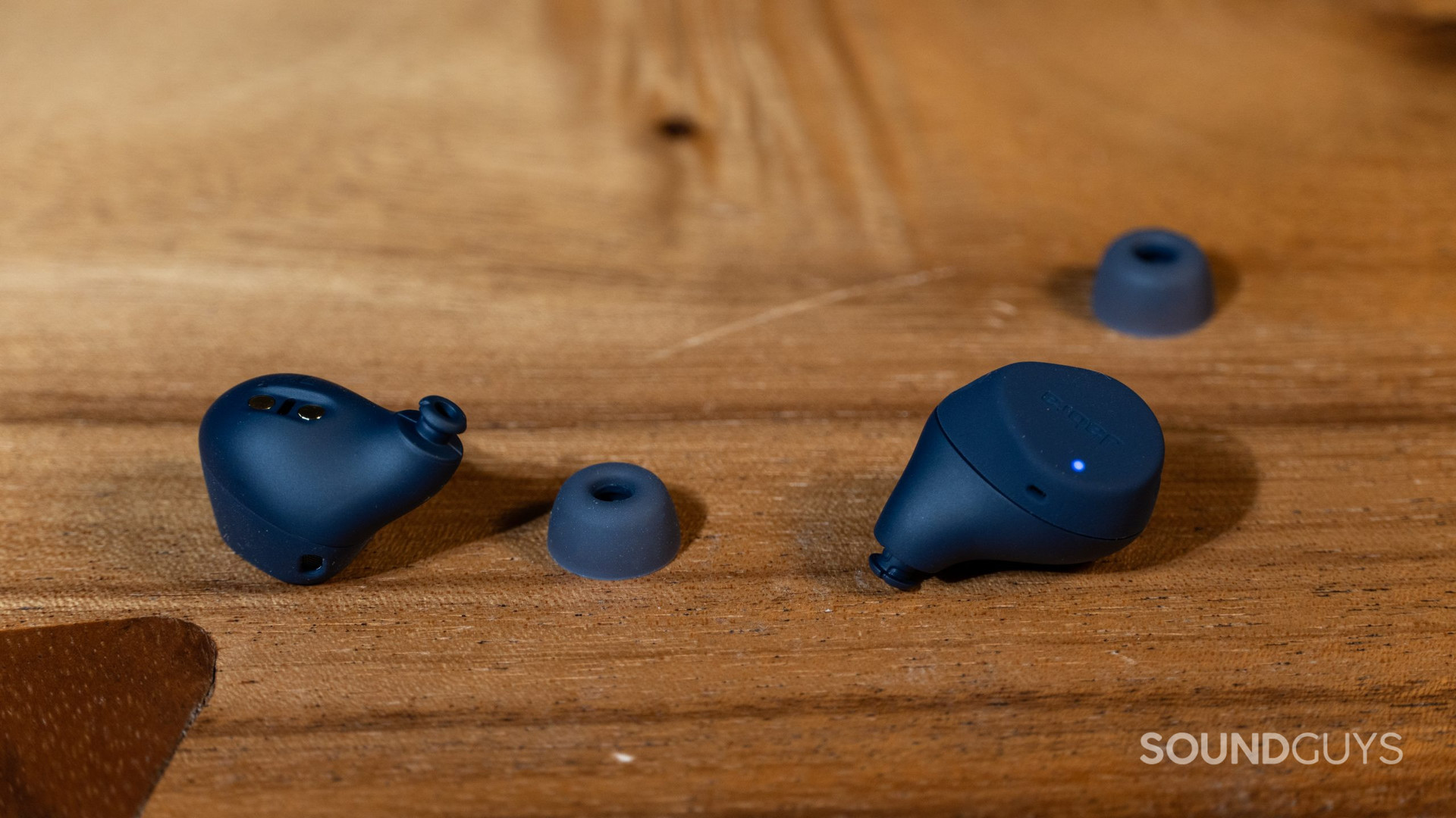 Jabra Elite 7 Active earbuds on table with eartips taken off.