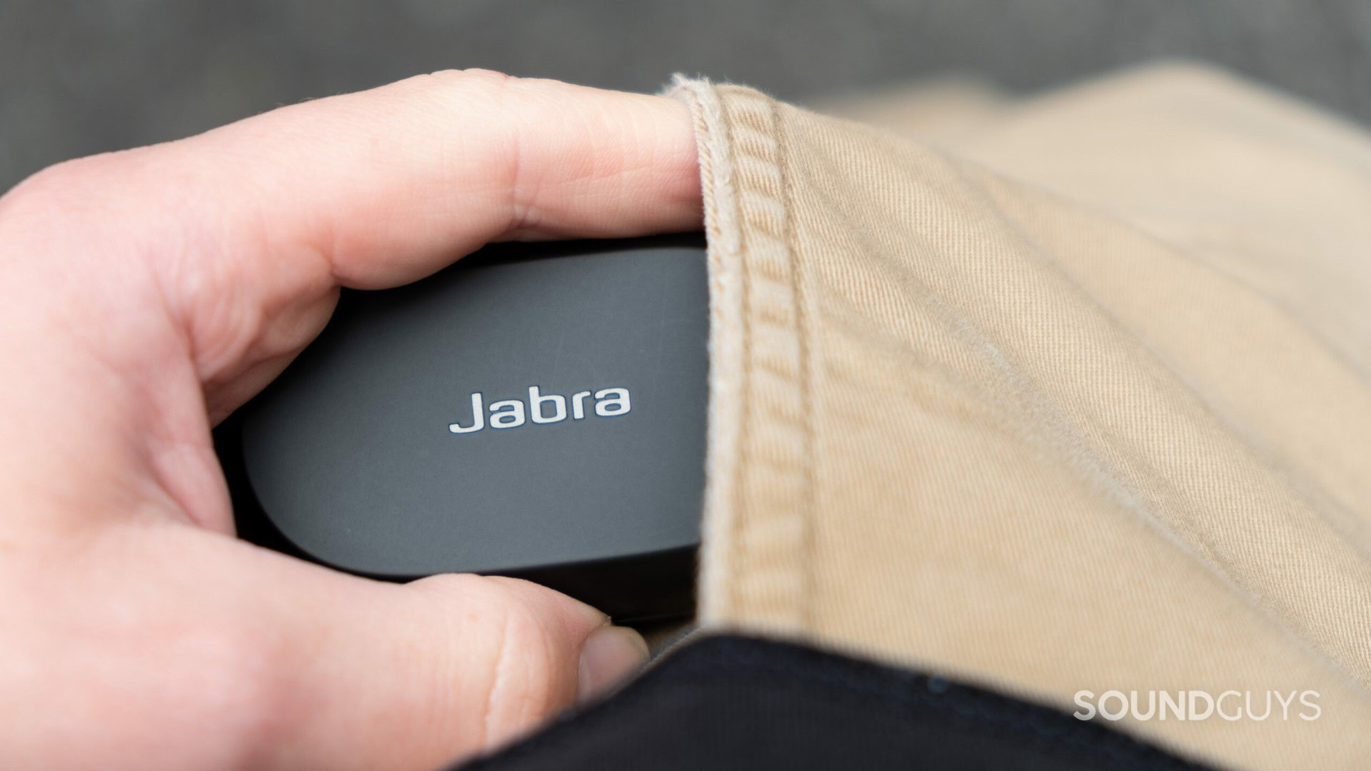 The Jabra Elite 7 Pro case being inserted into a pants pocket.