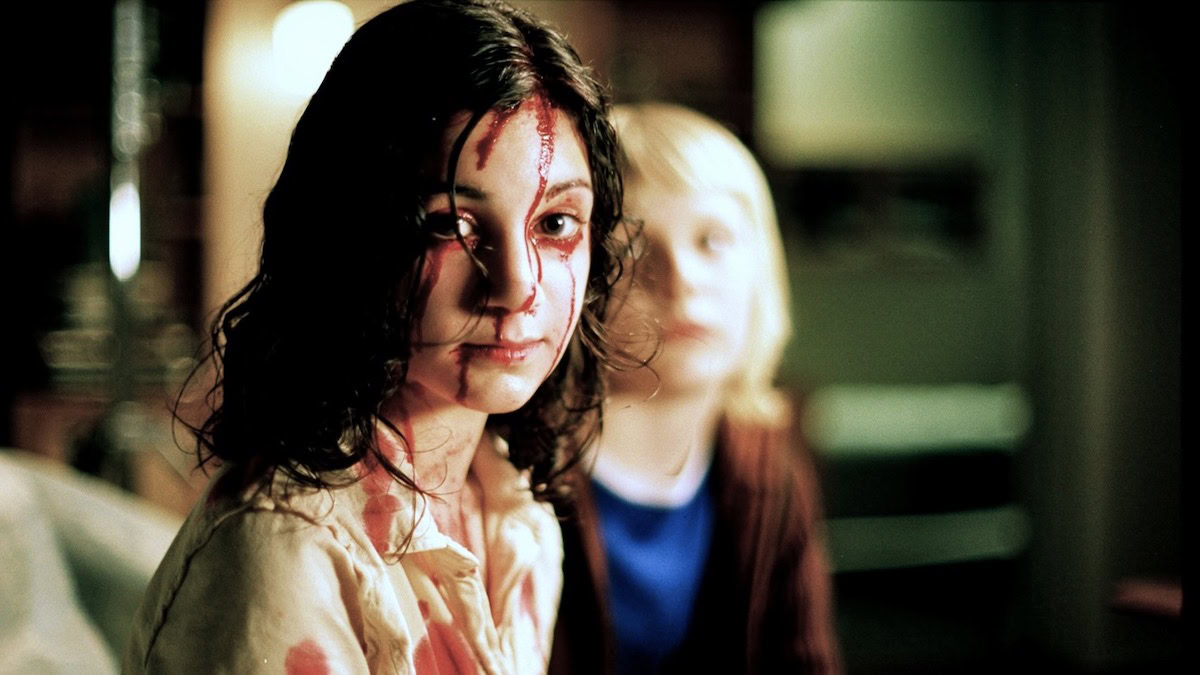 A child covered in blood in Let the Right One In