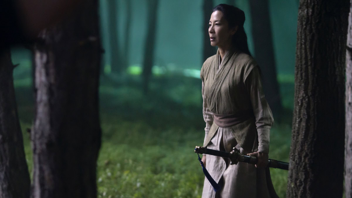 Michelle Yeoh as Lotus, carrying a sword in a forest at night in Marco Polo - shows like the last kingdom
