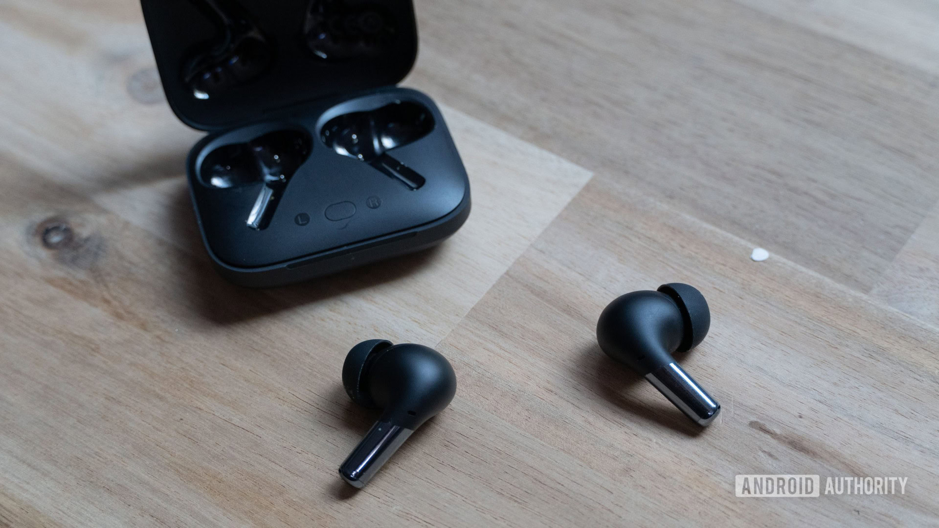 OnePlus Buds Pro laying on a table.