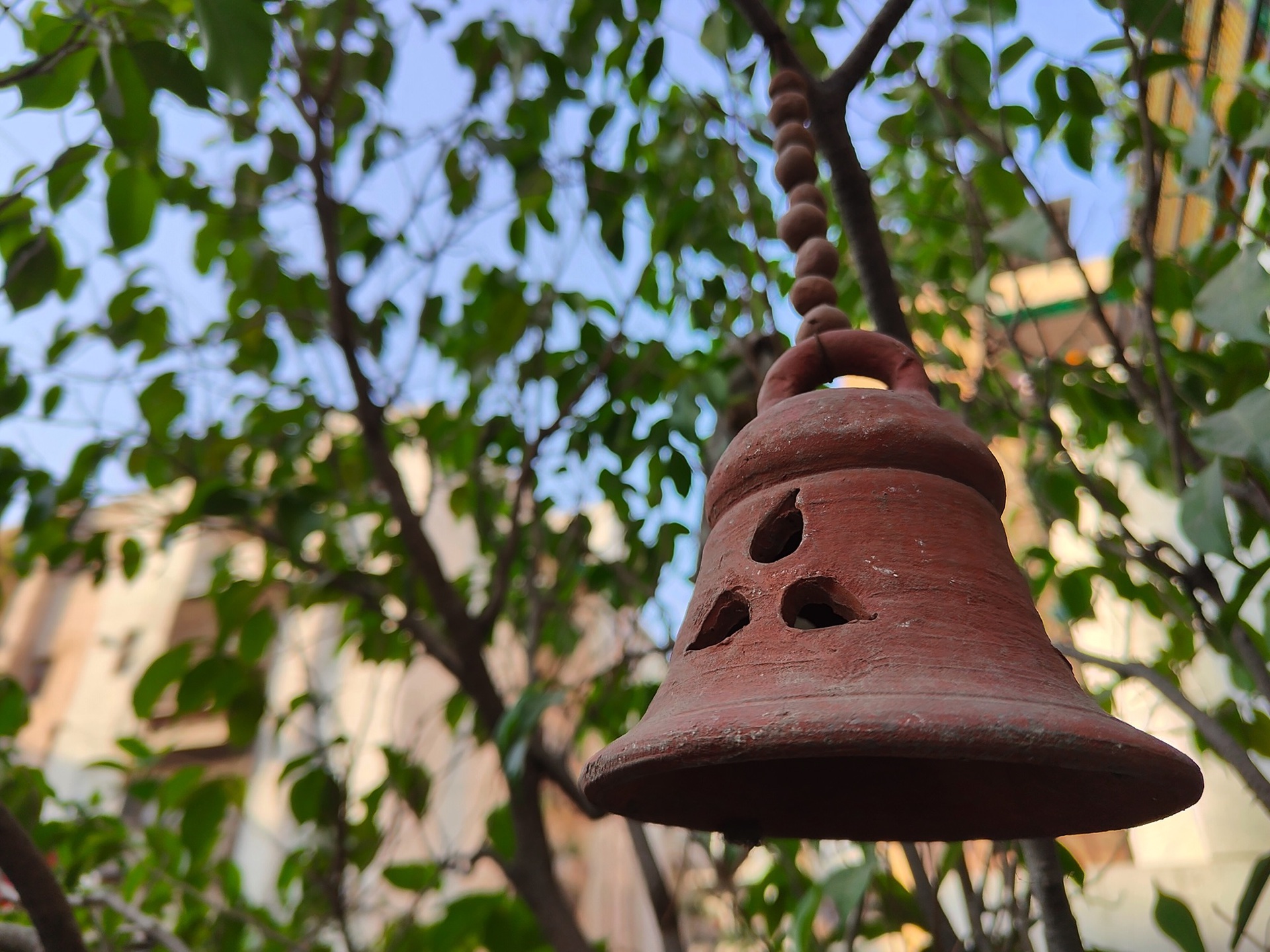 realme GT2 Pro camera sample photo of a bell hanging from a branch