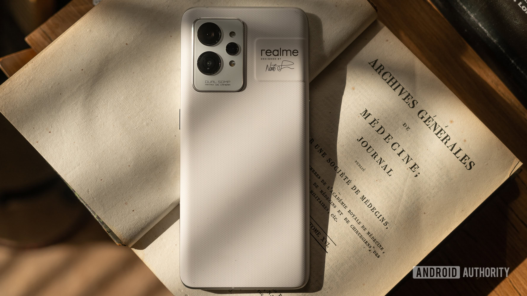 Realme GT2 Pro rear panel on top of a book.