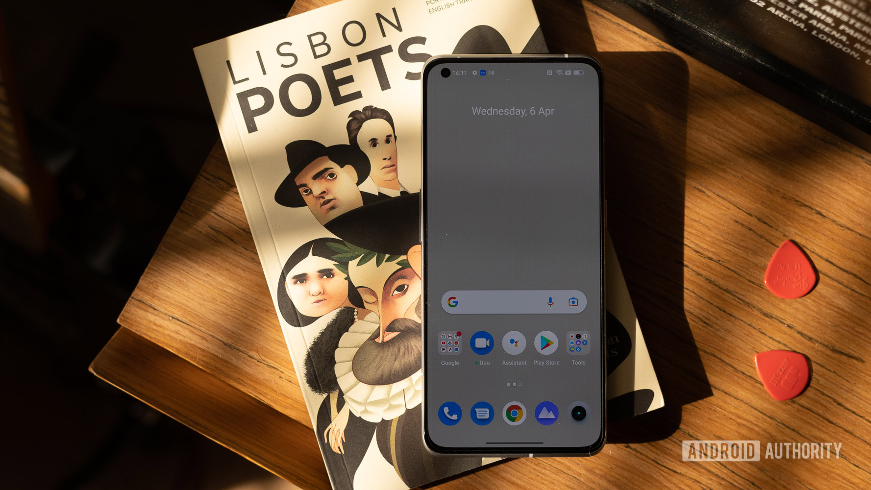 realme GT2 Pro top down of display on top of a book of Lisbon Poets.