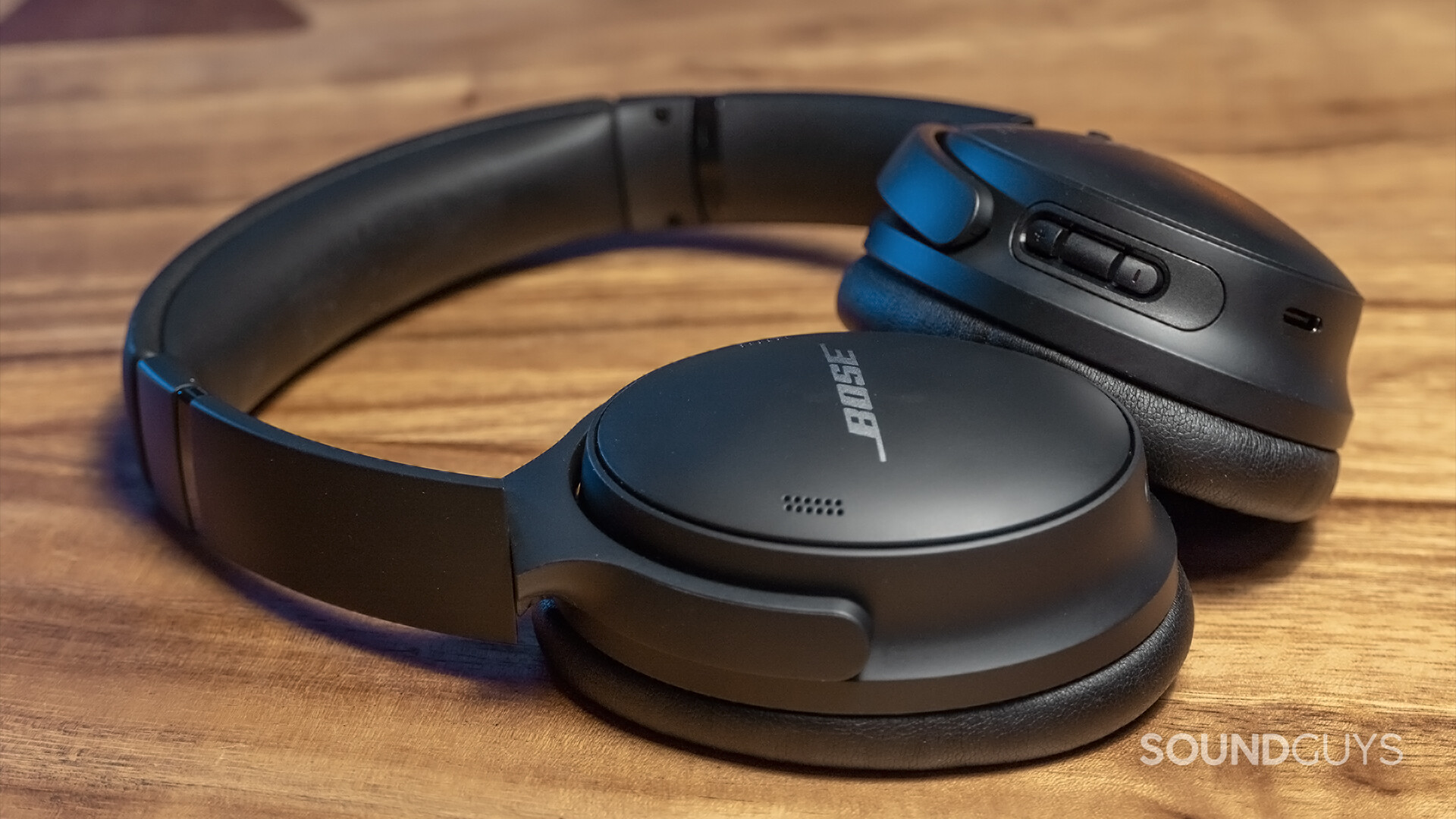 A photo of the Bose QuietComfort 45 resting on a wooden table.