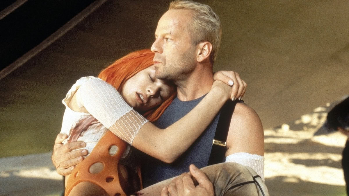 Bruce Willis carries Milla Jovovich in The Fifth Element - best bruce willis movies