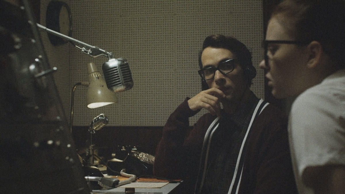 A man and girl at a radio booth in The Vast of Night - underrated movies