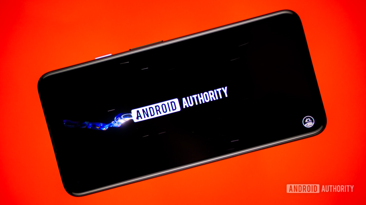 Smartphone showing Android Authority YouTube stock photo on a red background.