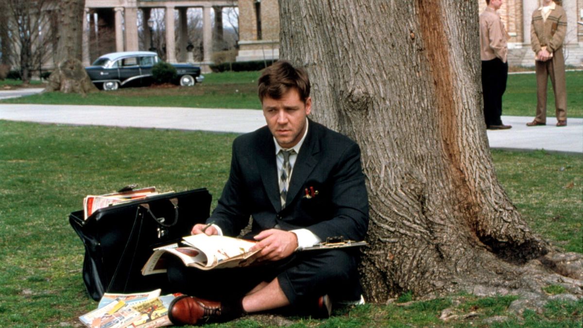 Russell Vrowe sits in the grass on campus in A Beautiful Mind - best movies leaving HBO Max