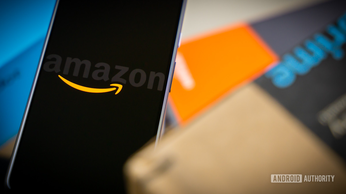 Amazon logo on phone next to box stock photo 12