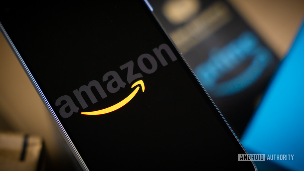 Amazon logo on phone next to boxes stock photo 5