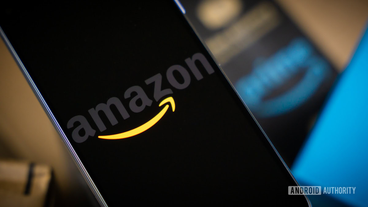 Amazon logo on phone next to boxes stock photo 5