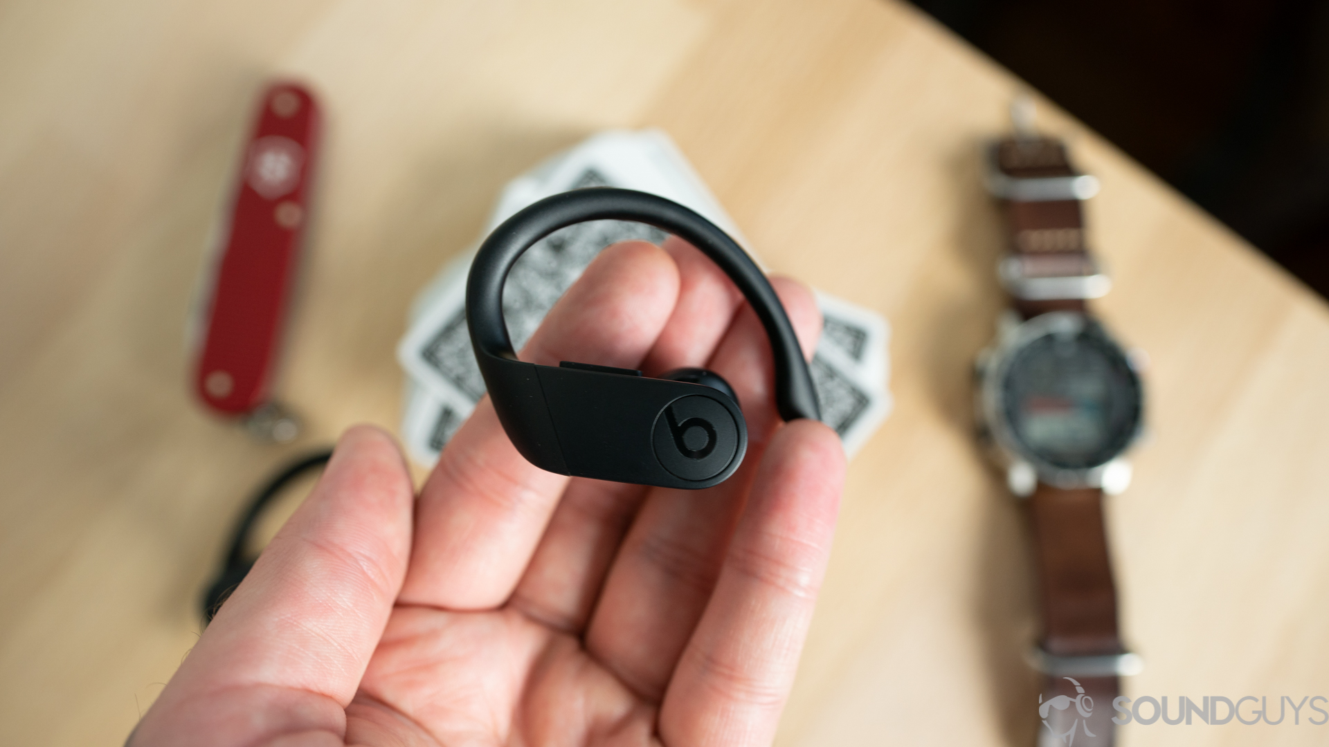 A photo of the Beats Powerbeats Pro in hand.