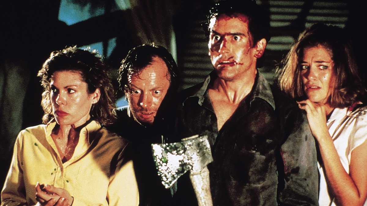 Ash and three other characters together in Evil Dead 2 - best sam raimi movies ranked