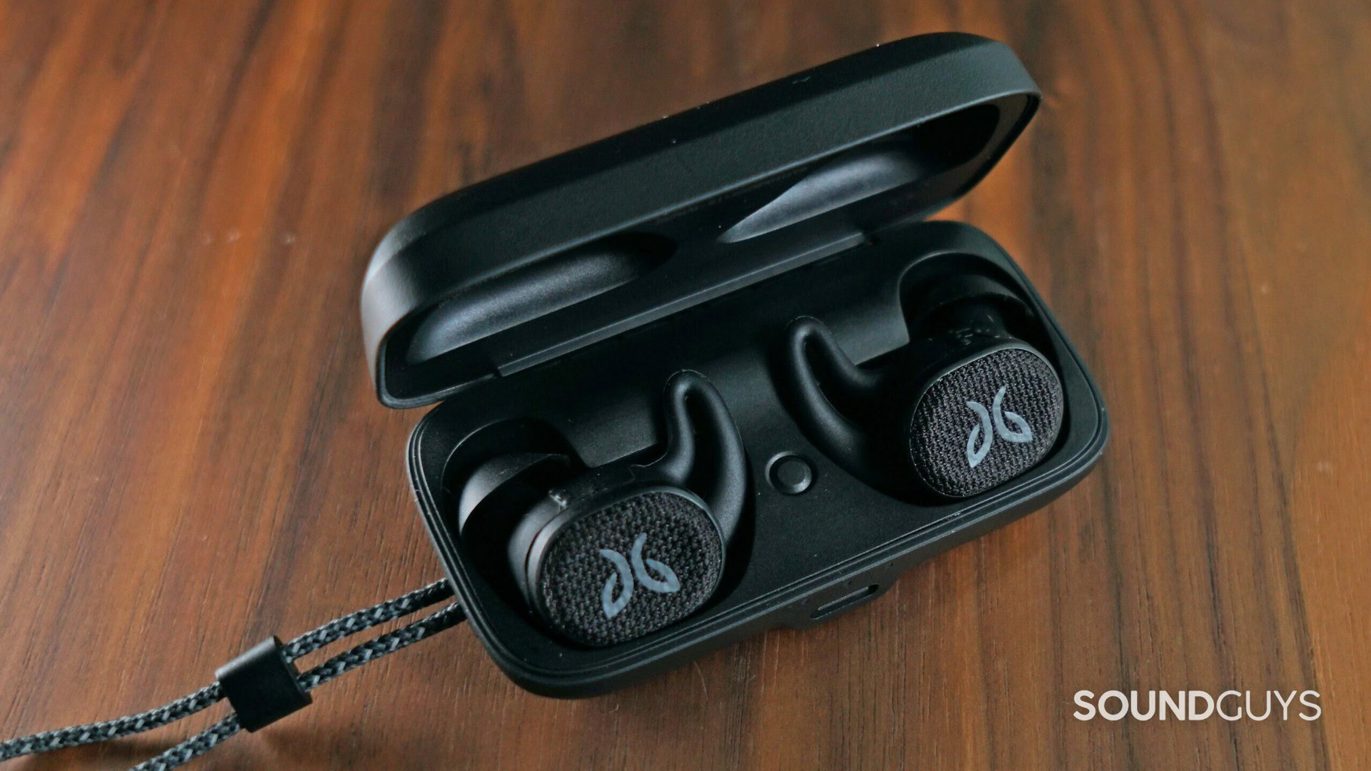 The Jaybird Vista 2 in black on top of a wood surface.