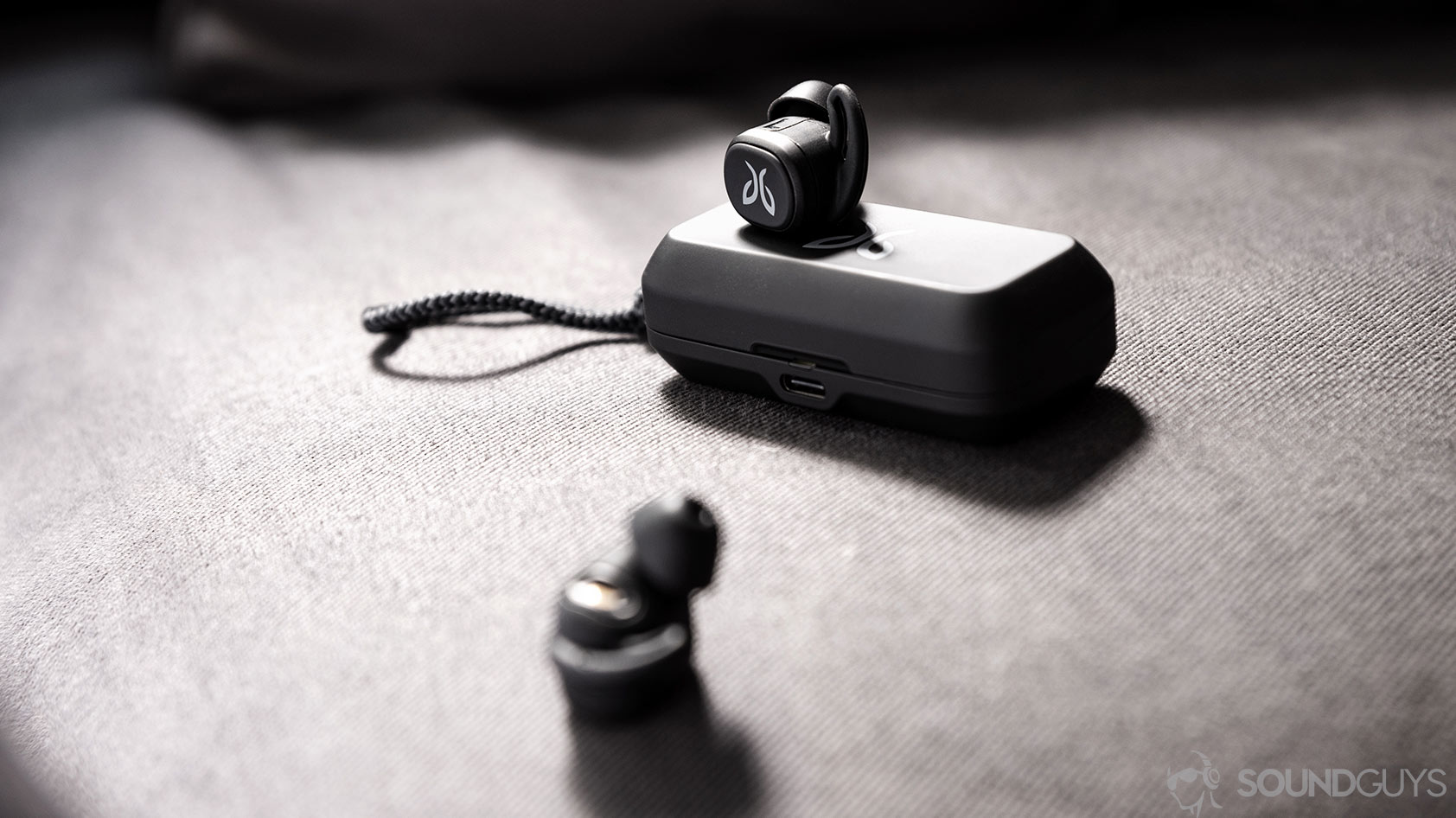 An image of the Jaybird Vista earbuds outside of the case with one resting on top and the other in the foreground.