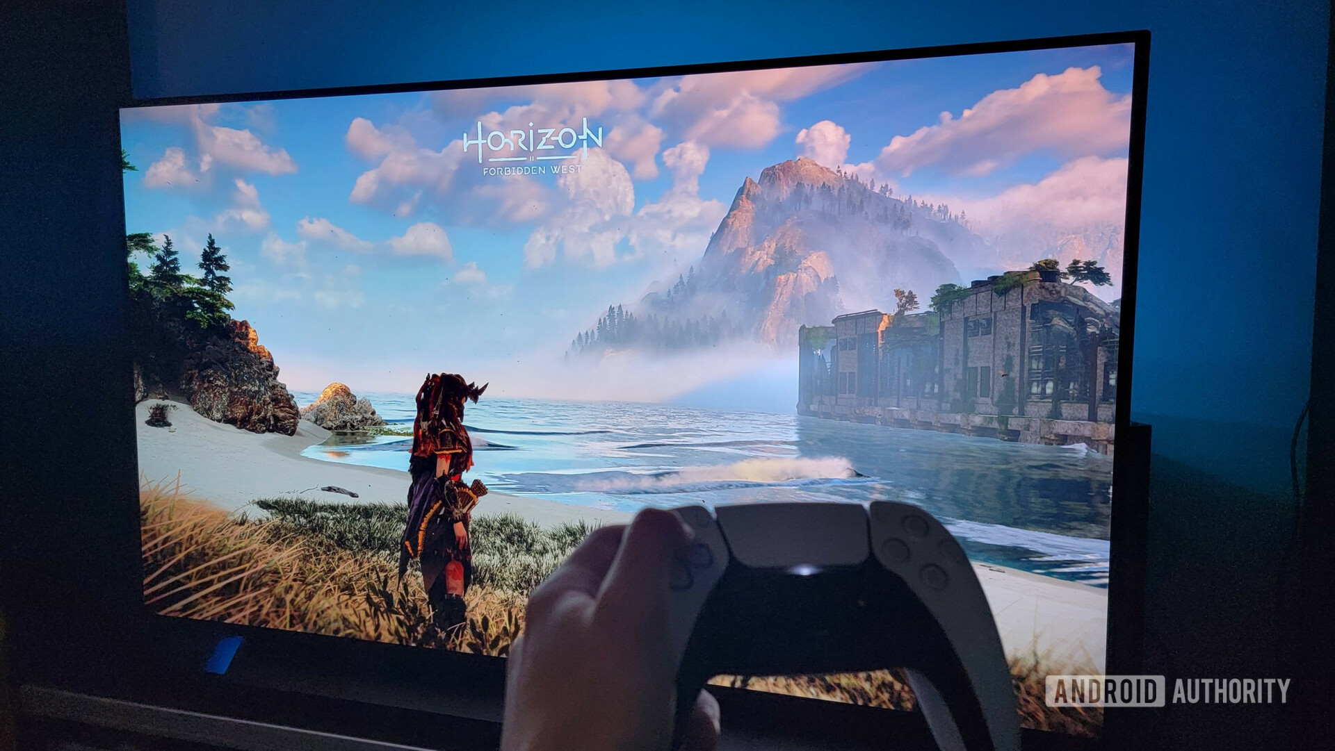 LG OLED C1 TV showing Horizon Forbidden West on PS5, with the PS5 controller in front of the screen.
