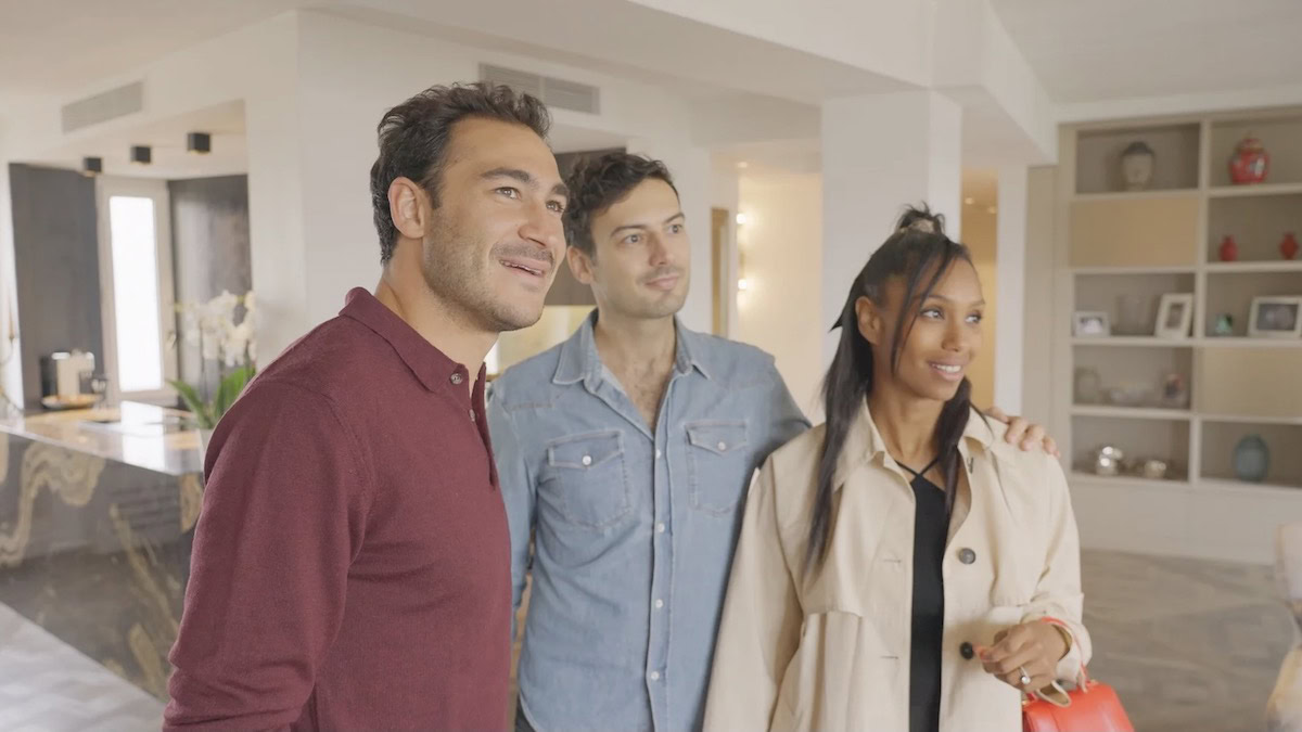 Three people stand in a Paris apartment in The Parisian Agency Exclusive Properties