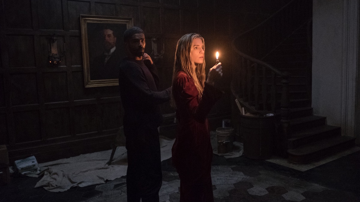 Brit Marling holds a flame in a dark room with a man in The OA - shows like shining girls