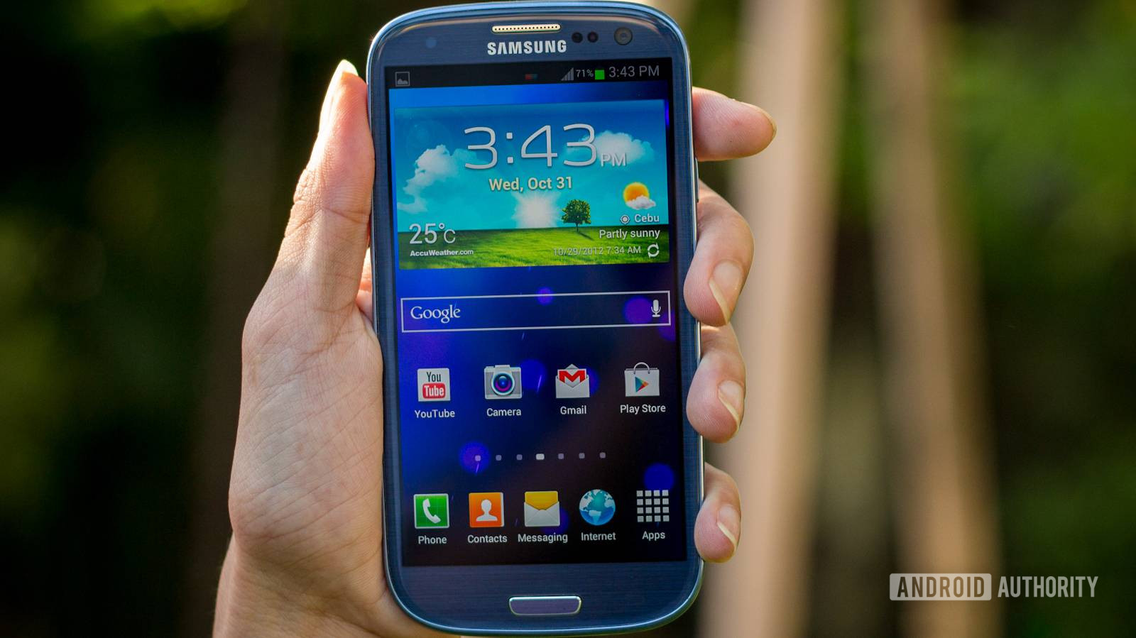 samsung galaxy s3 in hand with the screen on