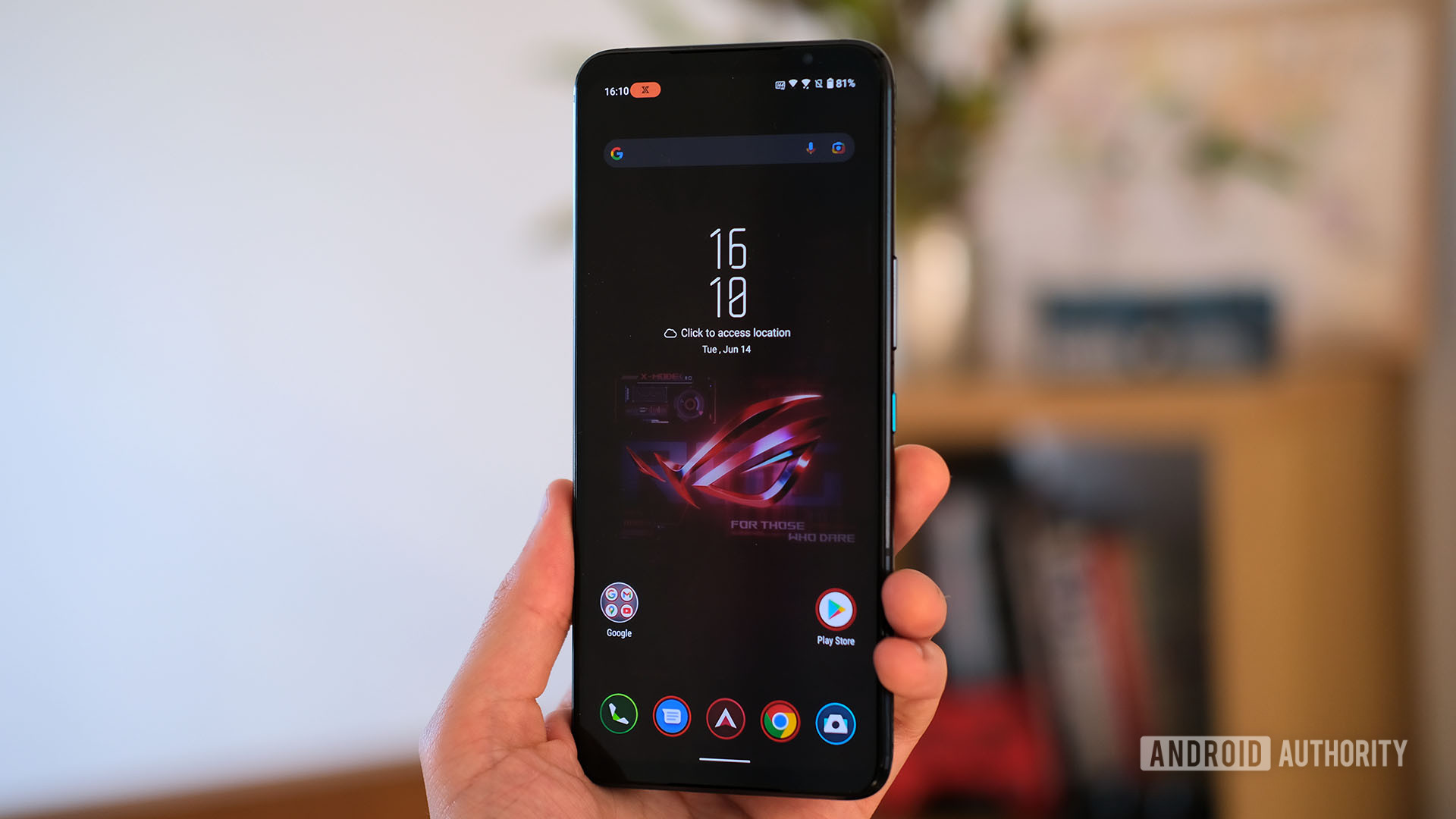 An ASUS Rog Phone 6 Pro X Mode being held by a hand showing its homescreen.
