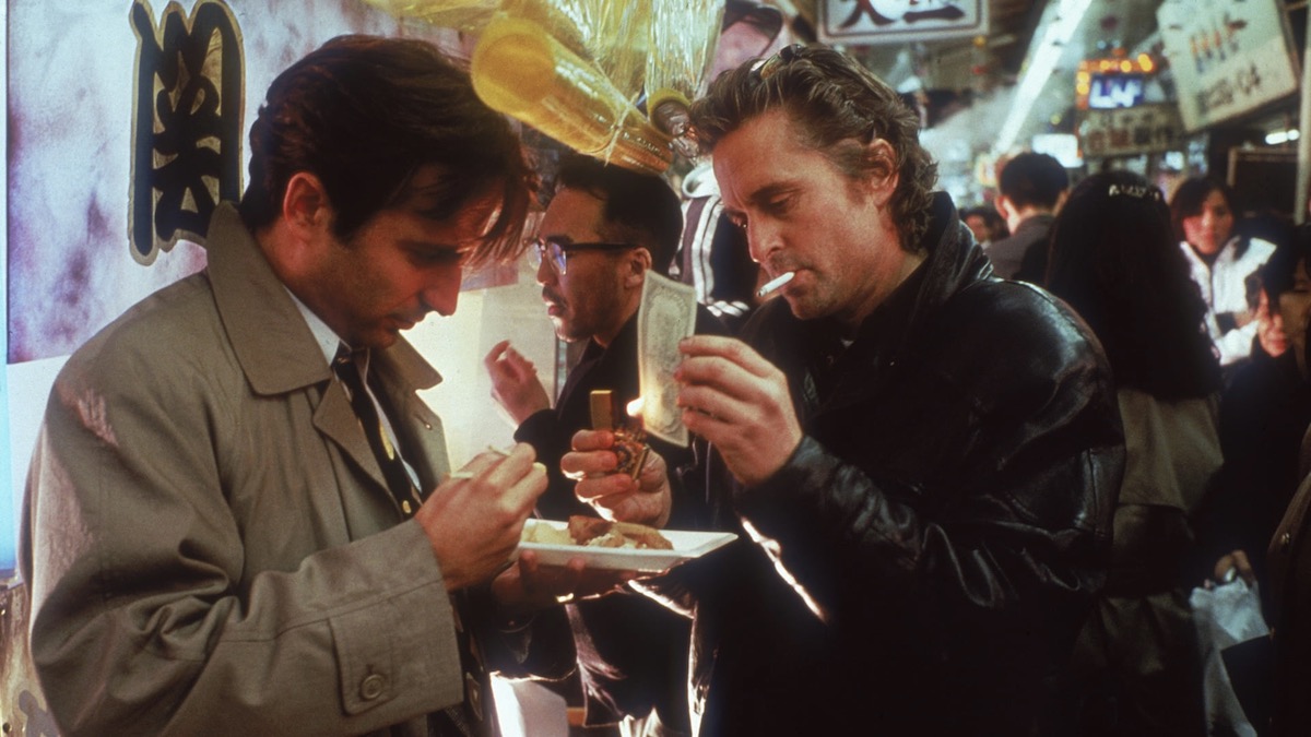 Michael Douglas lighting a cigarette with flaming cash, standing with Andy Garcia in Black Rain - movies like tokyo vice