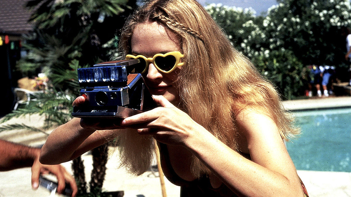 Heather Graham uses a camera by a pool in Boogie Nights - best new streaming movies