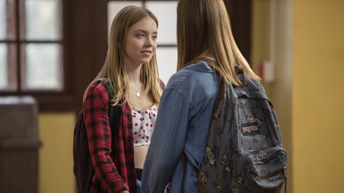 Two teen girls hold hands at school in Everything Sucks! - best lgbtq shows