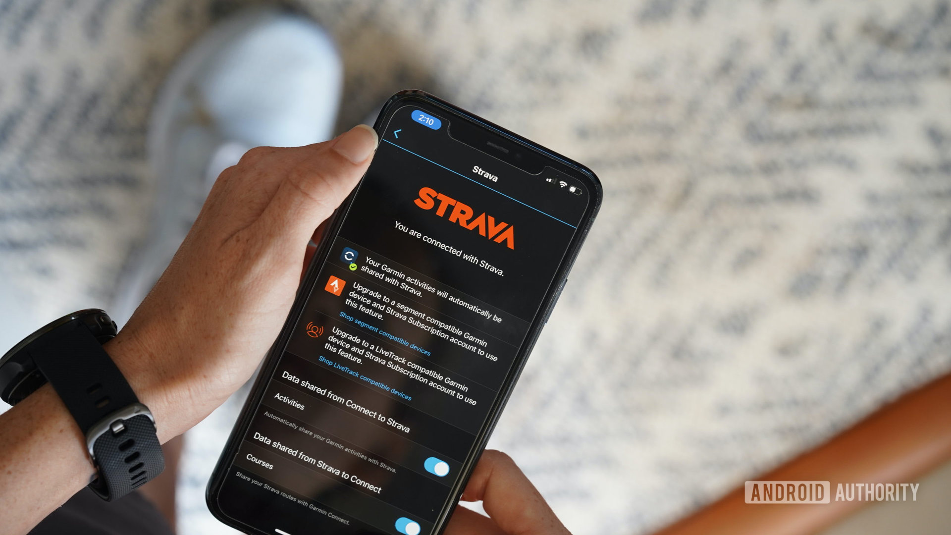 A Garmin wearables users links her Garmin Connect account to her Strava account on an iPhone 11.