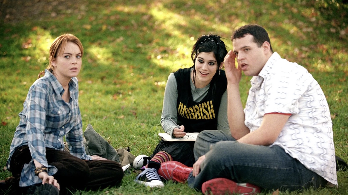 Three teens sit on the grass in Mean Girls - netflix's best comedies