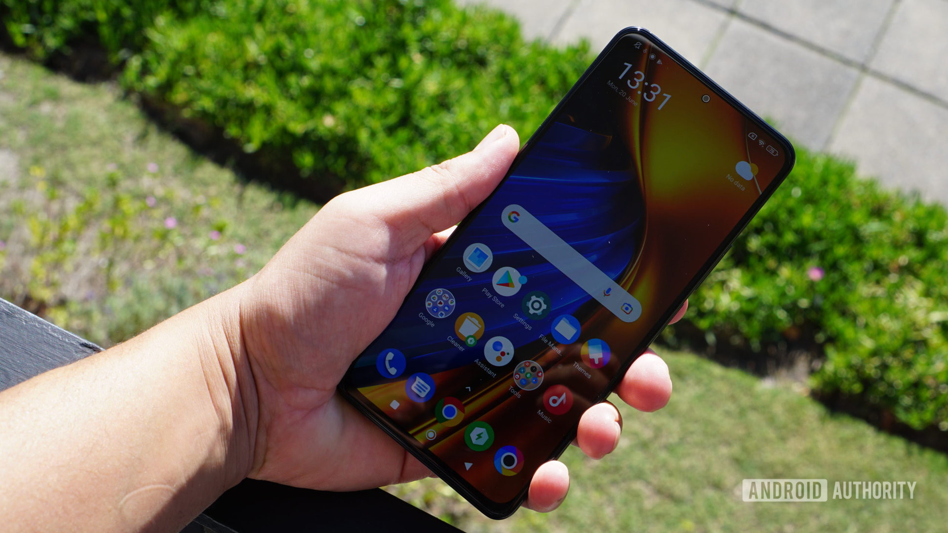 Poco F4 front in hand showing screen outside