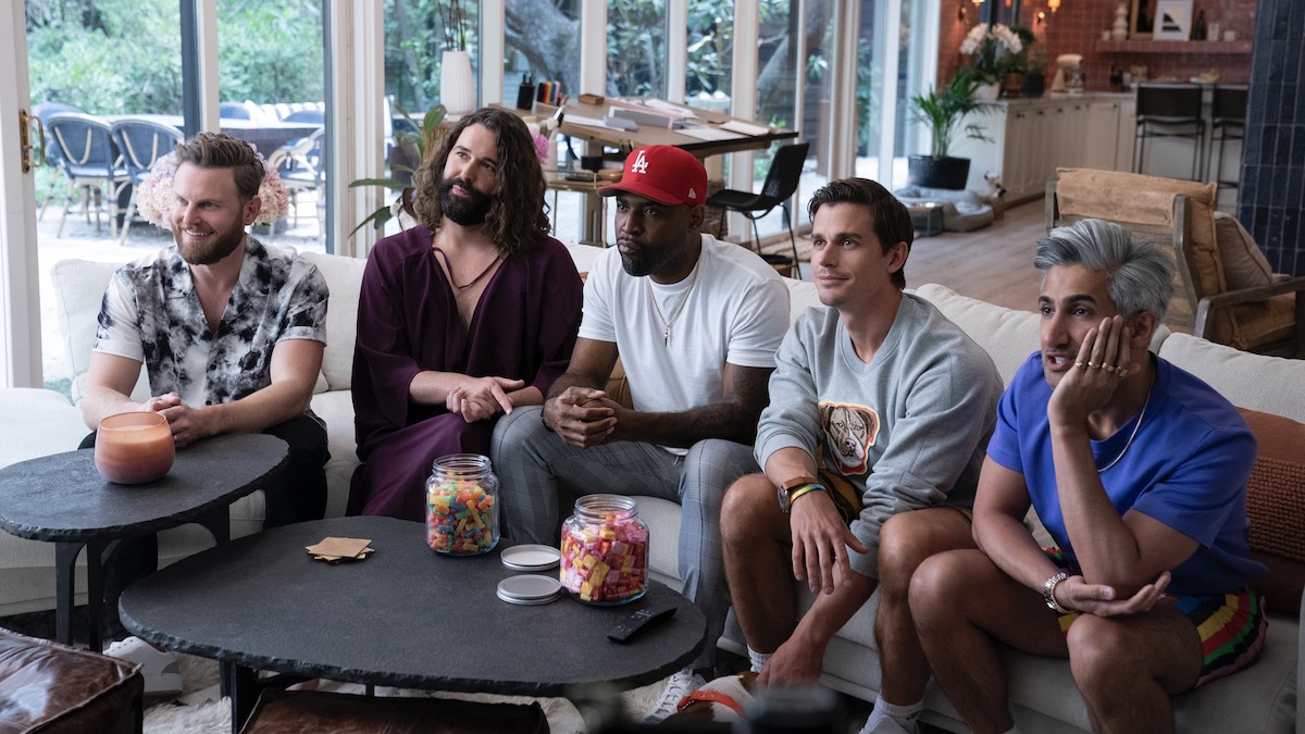 Queer Eye hosts sit together staring at a screen: the best lgbtq shows