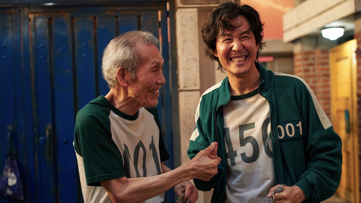 Two men shaking hands and smiling in Squid Games - netflix worth it