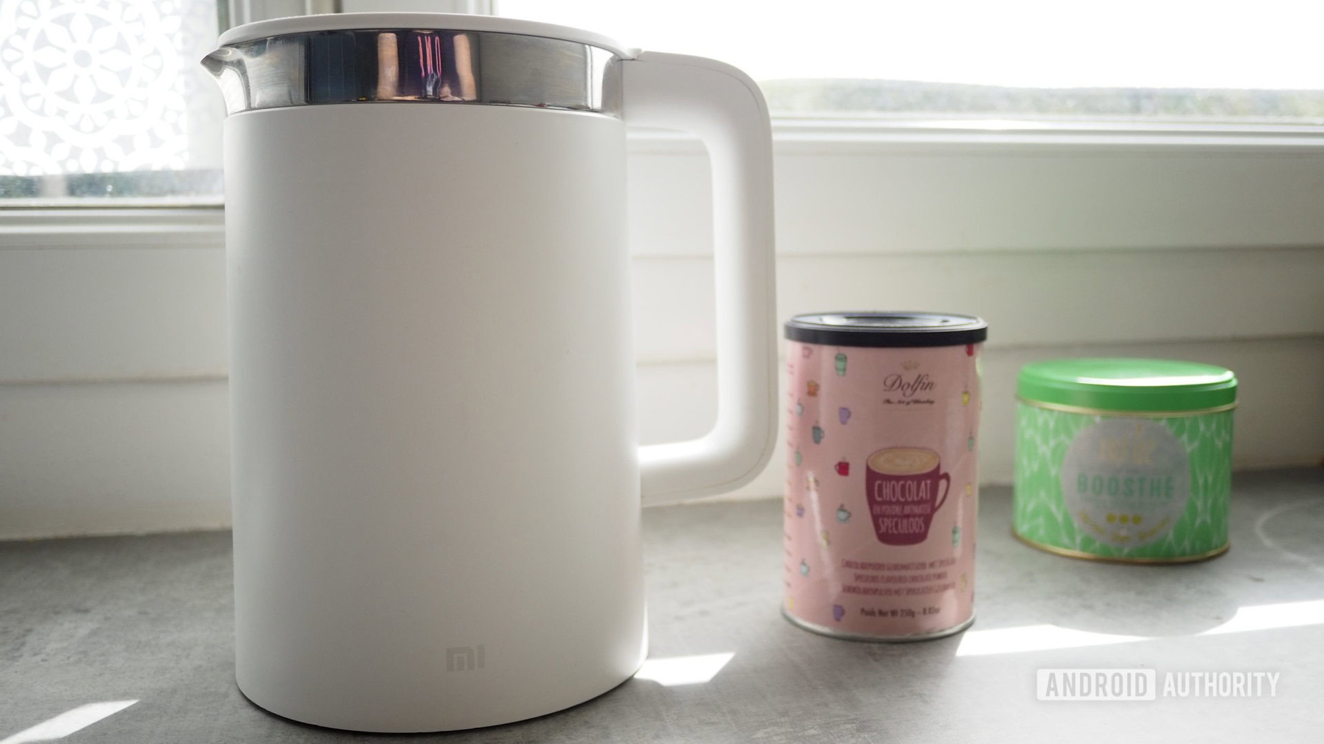 Xiaomi Mi Smart Kettle Pro on kitchen counter with cocoa and tea boxes in the background