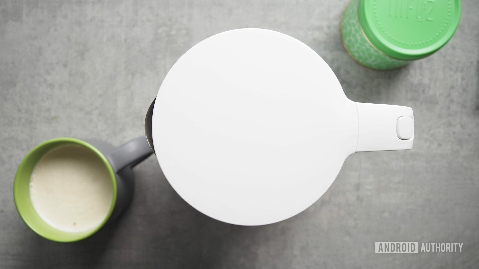 Xiaomi Mi Smart Kettle Pro on kitchen counter, seen from the top, with coffee mug and green tea box