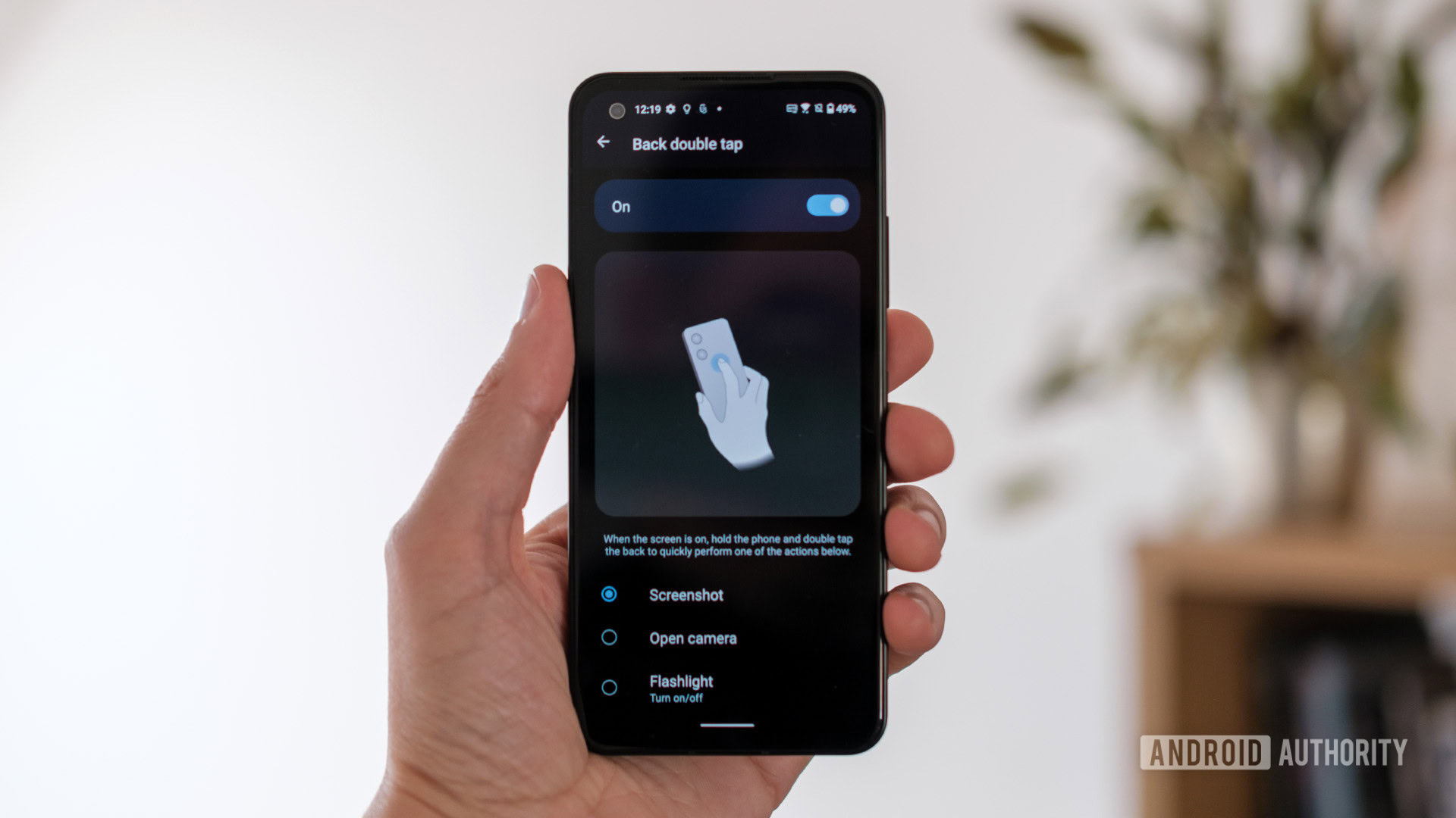 ASUS Zenfone 9 back double tap on display in hand